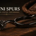 A polished black metal spur resting on a rustic wooden surface, illuminated by warm, dramatic lighting that highlights its sleek design. The background features soft leather textures, adding depth and warmth to the composition. Elegant serif text "BITNI SPURS" and the tagline "PRECISION. CONTROL. PERFORMANCE." are displayed above, emphasizing the product's quality.