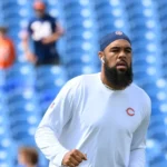 Keenan Allen warming up before an NFL game while wearing a white Chicago Bears training shirt, highlighting the Keenan Allen shoulder injury discussion and NFL fitness concerns.